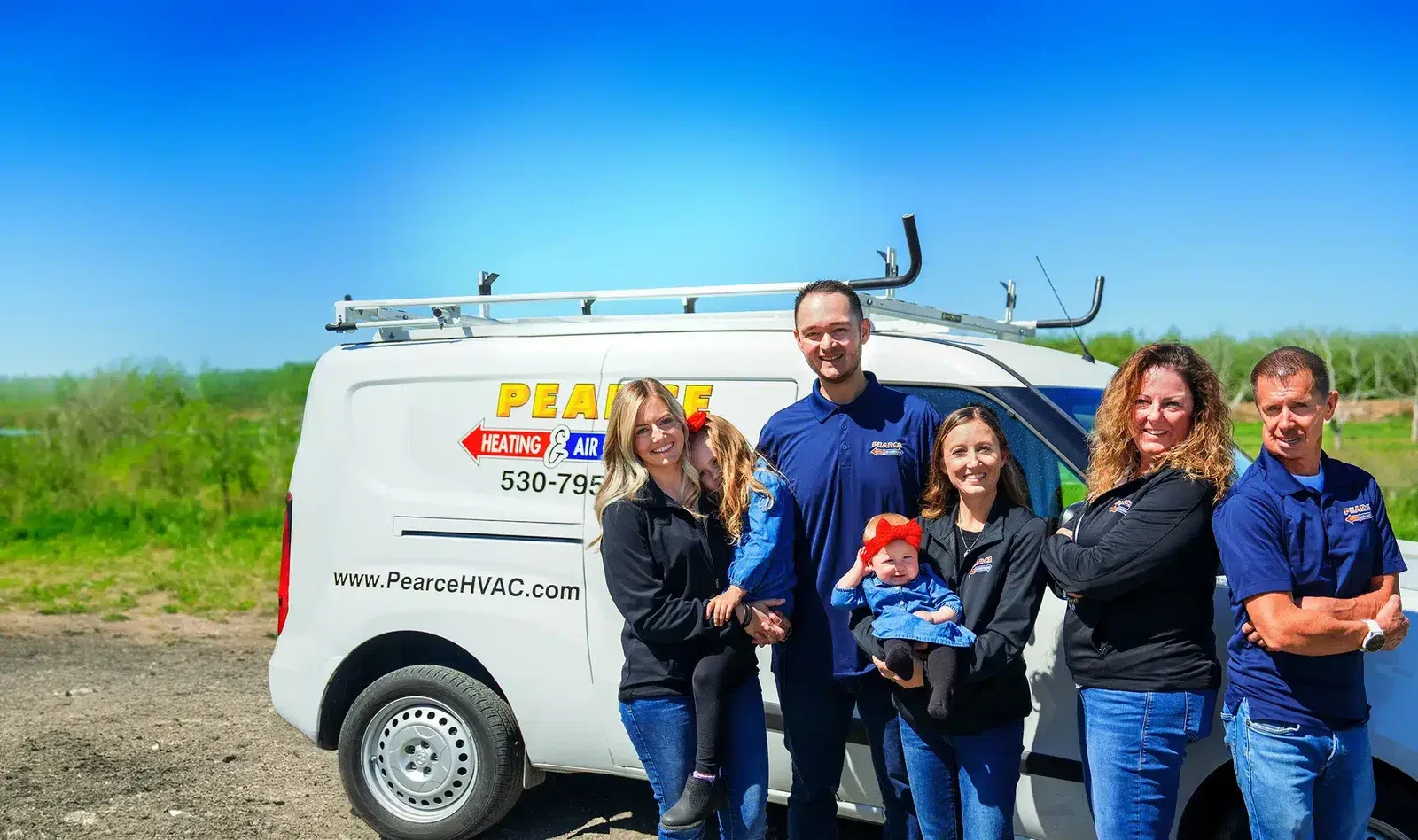 The Pearce Home Services family team in front of a Pearce service van